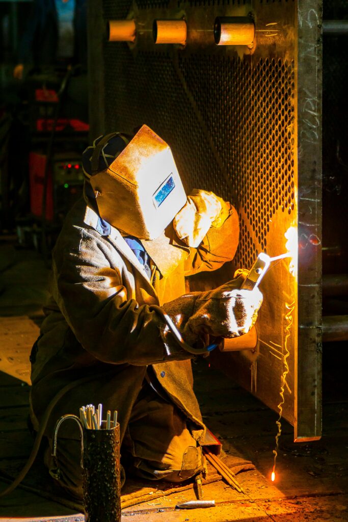 pexels-photo-2880871-2880871-1 A skilled welder works with a torch in an industrial environment, showcasing metalwork expertise.